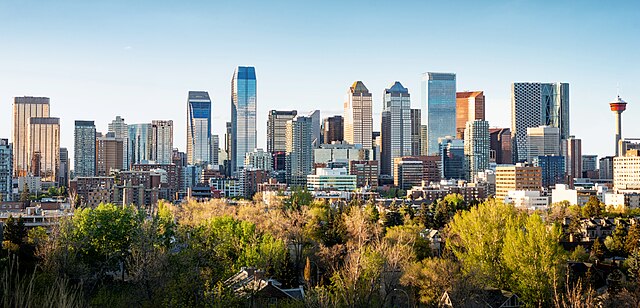 Vibrant city skyline with modern skyscrapers and lush green parks in the foreground.
